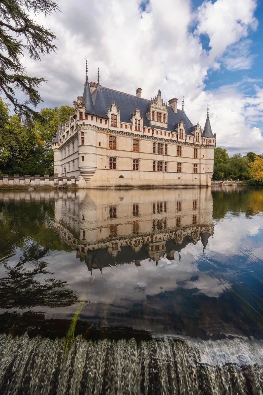 Château d'Azay-le-Rideau standing over the Indre with its turrets and roofline mirrored in the water below
